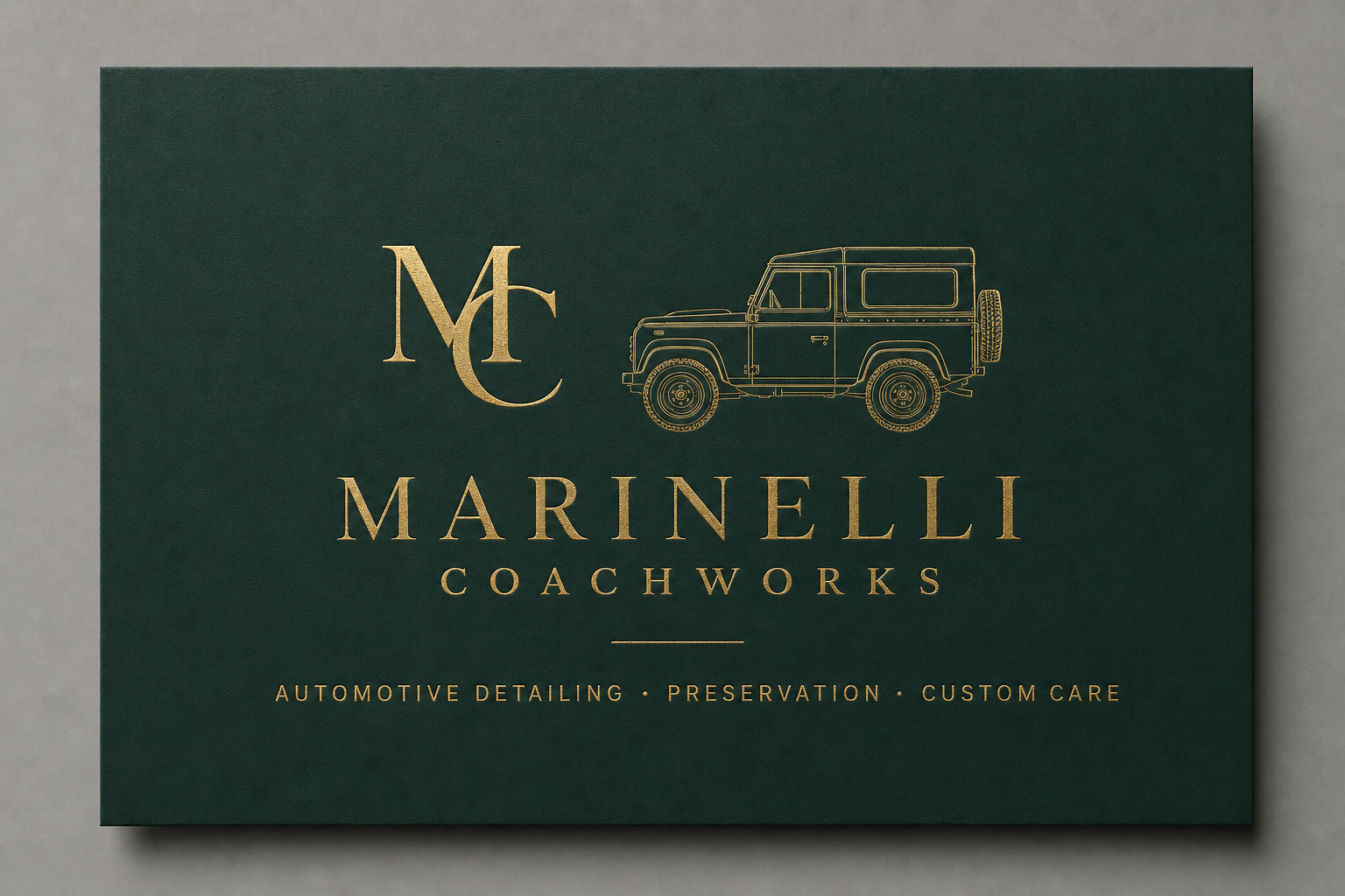 Green and gold Marinelli Coachworks card with Defender line art